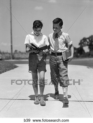 1930s two boys walking school reading books View Large Photo Image Stock Photo - 1930s two boys walking school reading books. Fotosearch
