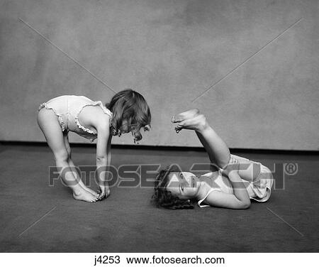 1930s two girls wearing underclothes playing at exercising View Large Photo Image Stock Image - 1930s two girls wearing underclothes playing at exercising. Fotosearch