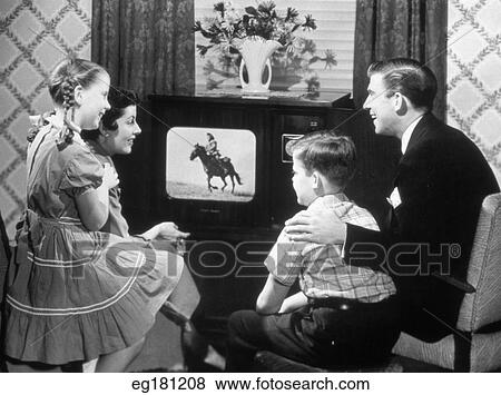 Stock Photo - 1940s 1950s family in front of television. Fotosearch