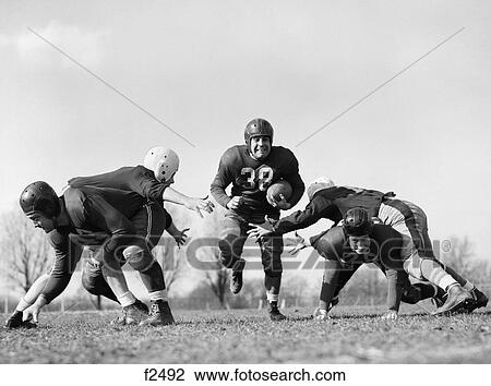 1940s 1950s five men playing football View Large Photo Image Stock Image - 1940s 1950s five men playing football. Fotosearch