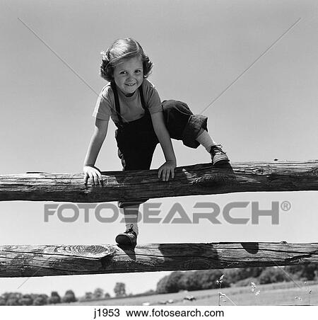 1940s 1950s smiling girl climbing over wooden fence View Large Photo Image Stock Image - 1940s 1950s smiling girl climbing over wooden fence. Fotosearch