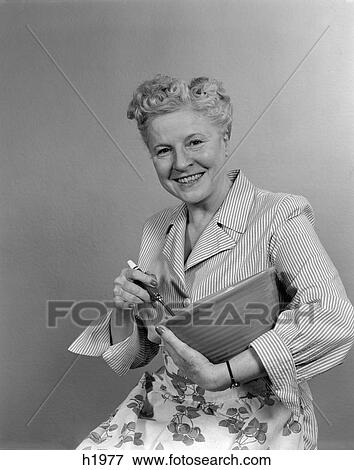1940s 1950s smiling woman housewife holding a mixing bowl looking at camera View Large Photo Image Stock Photo - 1940s 1950s smiling woman housewife holding a mixing bowl looking at camera . Fotosearch