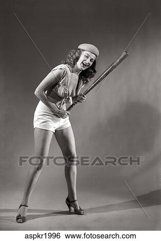 1940s 1950s smiling woman wearing halter top short shorts holding