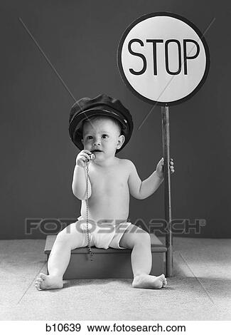 Stock Photo - 1940s baby boy holding stop sign traffic whistle. Fotosearch