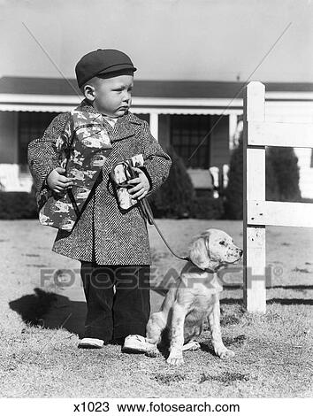 1940s boy with puppy on leash holding christmas present View Large Photo Image Stock Image - 1940s boy with puppy on leash holding christmas present. Fotosearch