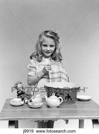 1940s child drying washing dishes doll View Large Photo Image Stock Photo - 1940s child drying washing dishes doll. Fotosearch