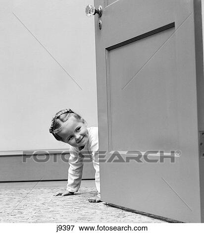 1940s child looking peering around door View Large Photo Image Stock Photo - 1940s child looking peering around door. Fotosearch