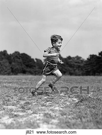 1940s child running playing on grass field View Large Photo Image Stock Image - 1940s child running playing on grass field. Fotosearch