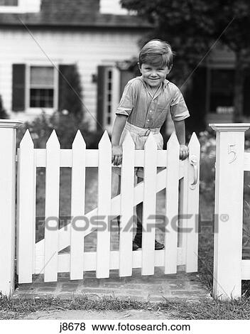 1940s child standing on fence smiling View Large Photo Image Stock Photo - 1940s child standing on fence smiling. Fotosearch