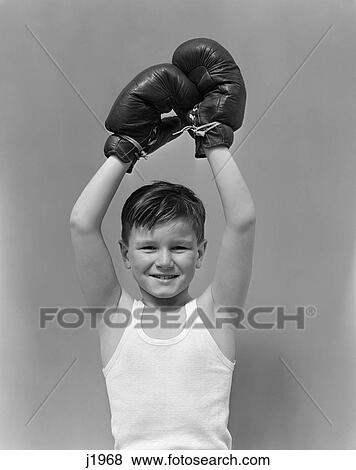 1940s child wearing boxing gloves holding hands about head View Large Photo Image Stock Photo - 1940s child wearing boxing gloves holding hands about head. Fotosearch