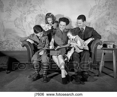 1940s family sitting on couch looking reading book View Large Photo Image Stock Photograph - 1940s family sitting on couch looking reading book. Fotosearch