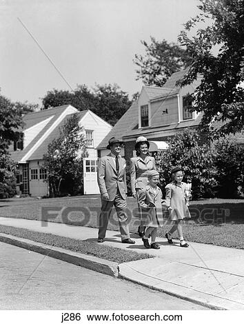 1940s family walking on sidewalk in front of house View Large Photo Image Stock Photograph - 1940s family walking on sidewalk in front of house. Fotosearch