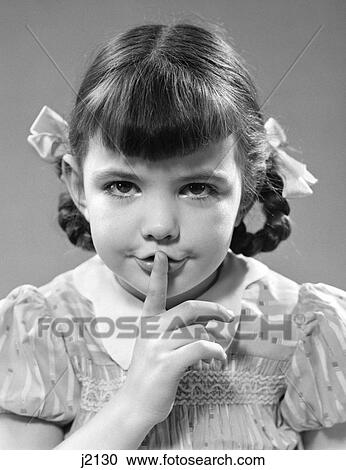 1940s girl holding finger to lips making shushing gesture View Large Photo Image Stock Image - 1940s girl holding finger to lips making shushing gesture. Fotosearch