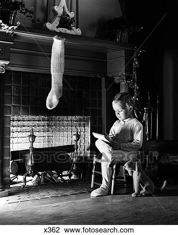 1940s little girl sitting beside fireplace with one christmas stocking writing a letter View Large Photo Image Stock Image - 1940s little girl sitting beside fireplace with one christmas stocking writing a letter. Fotosearch