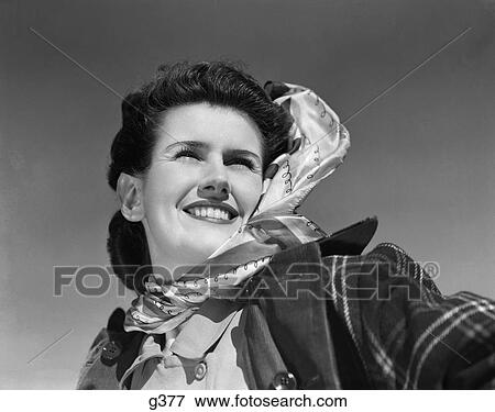1940s portrait of smiling woman wearing silk scarf plaid overcoat outdoors View Large Photo Image Stock Photo - 1940s portrait of smiling woman wearing silk scarf plaid overcoat outdoors. Fotosearch