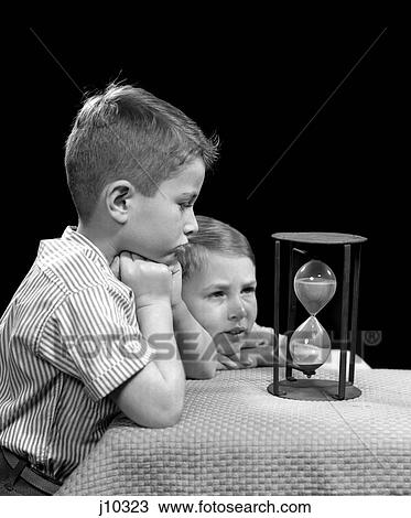 1940s two boys looking hourglass time sand waiting View Large Photo Image Stock Image - 1940s two boys looking hourglass time sand waiting. Fotosearch