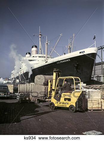 1950s 1960s cargo being loaded unloaded freighter ship north river pier new york city ny View Large Photo Image Picture - 1950s 1960s cargo being loaded unloaded freighter ship north river pier new york city ny. Fotosearch