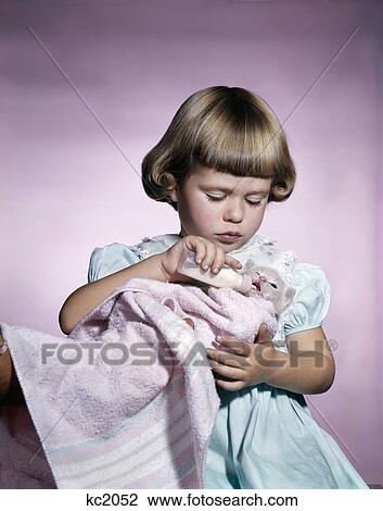 1950s 1960s little girl feeding kitten with a baby bottle of milk studio View Large Photo Image Stock Image - 1950s 1960s little girl feeding kitten with a baby bottle of milk studio. Fotosearch