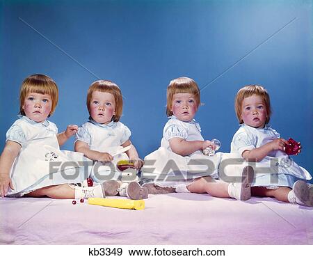 1950s 1960s portrait of quadruplets 4 red haired girls wearing dresses sitting in a row View Large Photo Image Stock Photo - 1950s 1960s portrait of quadruplets 4 red haired girls wearing dresses sitting in a row. Fotosearch