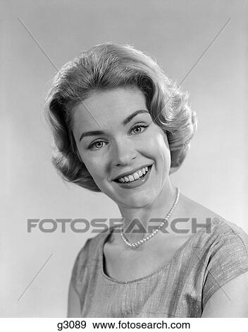 Stock Photo - 1950s 1960s portrait smiling blond woman wearing pearl necklace. Fotosearch