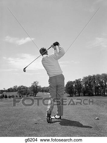 1950s 1960s rear view man swinging golf club View Large Photo Image Picture - 1950s 1960s rear view man swinging golf club. Fotosearch