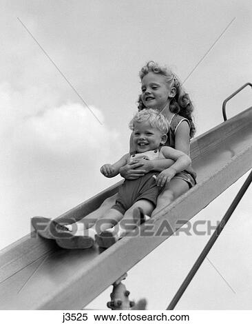 1950s 1960s two smiling children going down playground slide View Large Photo Image Stock Photography - 1950s 1960s two smiling children going down playground slide. Fotosearch