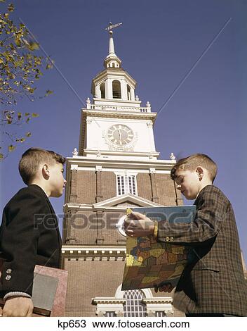 1950s 1960s two young boys standing independence hall holding books map school trip View Large Photo Image Stock Image - 1950s 1960s two young boys standing independence hall holding books map school trip. Fotosearch