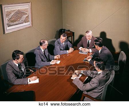 1950s 6 men around office conference table having serious business meeting discussion View Large Photo Image Picture - 1950s 6 men around office conference table having serious business meeting discussion. Fotosearch