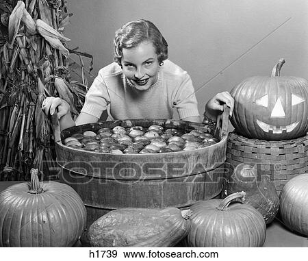 1950s apple bobbing pumpkins party jack-o'-lantern View Large Photo Image Stock Photo - 1950s apple bobbing pumpkins party jack-o'-lantern. Fotosearch