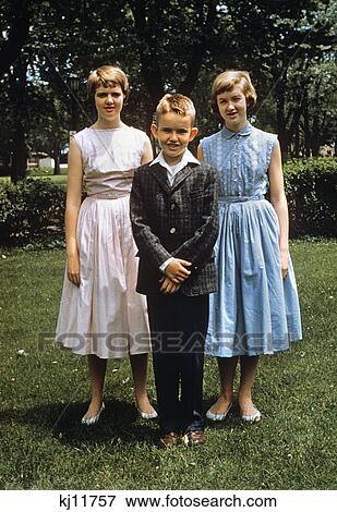 1950s boy and two teenage girls posing for photo in yard View Large Photo Image Stock Photo - 1950s boy and two teenage girls posing for photo in yard. Fotosearch