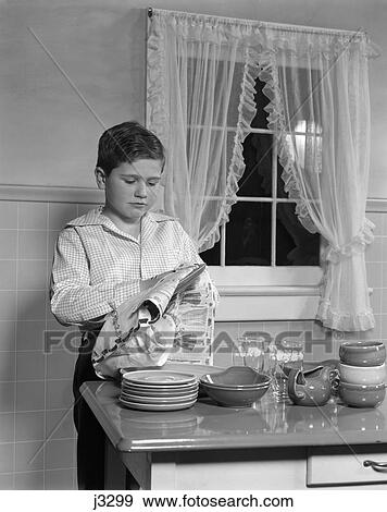 1950s child drying dishes kitchen table View Large Photo Image Stock Photo - 1950s child drying dishes kitchen table. Fotosearch