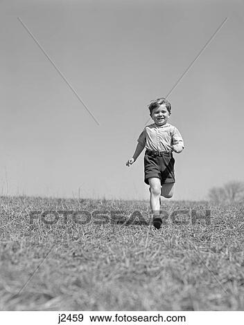 1950s child running on grass through field View Large Photo Image Stock Photo - 1950s child running on grass through field. Fotosearch