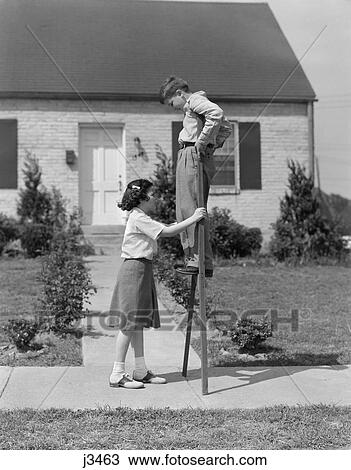 1950s children playing with stilts standing on sidewalk View Large Photo Image Stock Image - 1950s children playing with stilts standing on sidewalk. Fotosearch