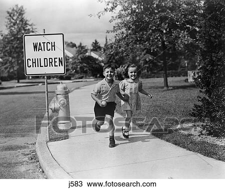1950s children skipping walking on sidewalk watch children sign View Large Photo Image Stock Image - 1950s children skipping walking on sidewalk watch children sign. Fotosearch