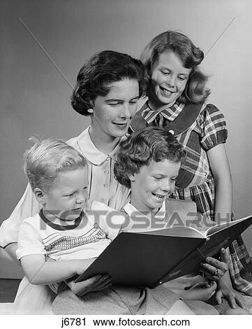 1950s family looking at book View Large Photo Image Stock Image - 1950s family looking at book. Fotosearch