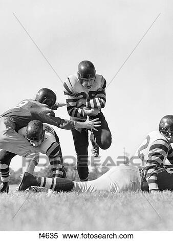 1950s five men playing football one player running holding ball View Large Photo Image Stock Photography - 1950s five men playing football one player running holding ball. Fotosearch
