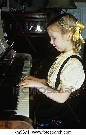 1950s little blond girl playing practicing the piano View Large Photo Image Stock Image - 1950s little blond girl playing practicing the piano. Fotosearch