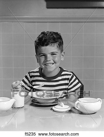 1950s smiling boy eating breakfast cereal View Large Photo Image Stock Photography - 1950s smiling boy eating breakfast cereal. Fotosearch