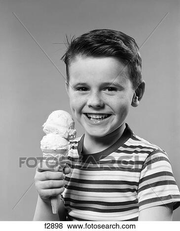 1950s smiling boy eating double dip ice cream cone View Large Photo Image Stock Photo - 1950s smiling boy eating double dip ice cream cone. Fotosearch