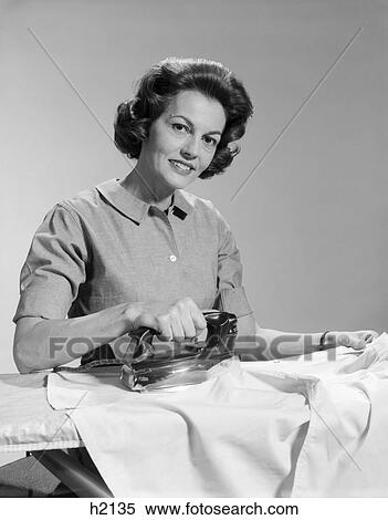 1950s smiling woman housewife ironing shirt looking at camera View Large Photo Image Stock Photography - 1950s smiling woman housewife ironing shirt looking at camera. Fotosearch