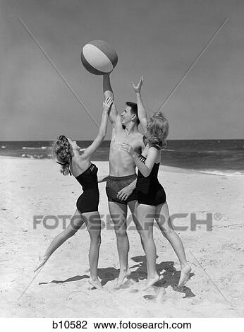 1950s teens jumping for beach ball wearing swim suits View Large Photo Image Stock Image - 1950s teens jumping for beach ball wearing swim suits. Fotosearch