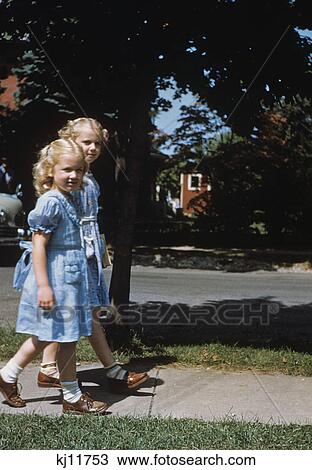 1950s two blond girls wearing blue dresses on the first day of school View Large Photo Image Stock Image - 1950s two blond girls wearing blue dresses on the first day of school. Fotosearch
