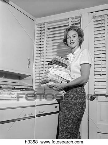1950s woman laundry fold washer dryer View Large Photo Image Stock Photo - 1950s woman laundry fold washer dryer. Fotosearch