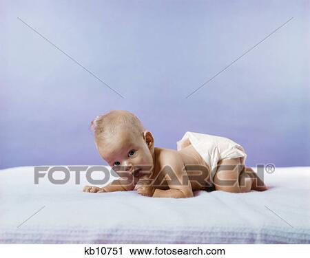 1960s 1970s baby wearing diaper crawling on blue blanket View Large Photo Image Stock Image - 1960s 1970s baby wearing diaper crawling on blue blanket. Fotosearch