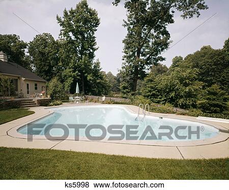 1960s 1970s backyard home in ground pool View Large Photo Image Stock Photo - 1960s 1970s backyard home in ground pool. Fotosearch