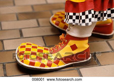 1960s 1970s big foot funny silly clumsy oversize red & yellow check clown shoes View Large Photo Image Stock Image - 1960s 1970s big foot funny silly clumsy oversize red & yellow check clown shoes. Fotosearch