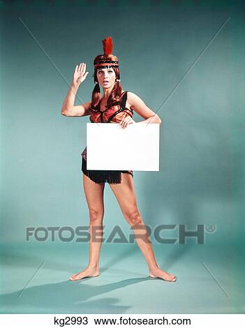 1960s 1970s character woman wearing native american feather headdress making how gesture holding blank sign View Large Photo Image Stock Image - 1960s 1970s character woman wearing native american feather headdress making how gesture holding blank sign. Fotosearch