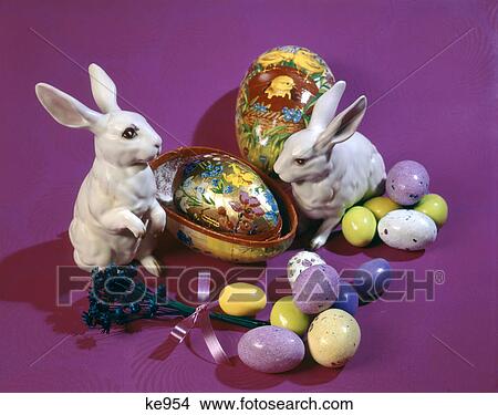 1960s 1970s easter rabbit figurines and candy malted eggs on a bright purple backdrop View Large Photo Image Picture - 1960s 1970s easter rabbit figurines and candy malted eggs on a bright purple backdrop. Fotosearch