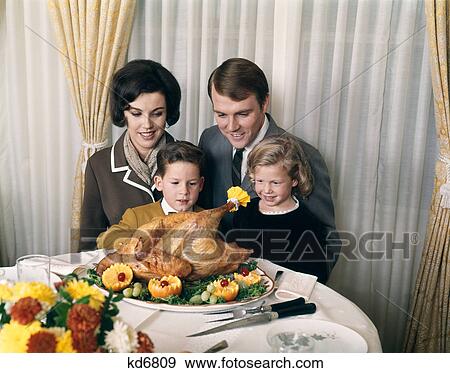 1960s 1970s family portrait with holiday roasted turkey on dining table View Large Photo Image Stock Photo - 1960s 1970s family portrait with holiday roasted turkey on dining table. Fotosearch