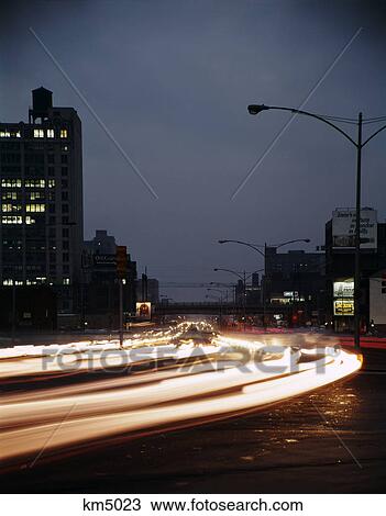 Stock Image - 1960s 1970s night blur motion traffic philadelphia 10th street and vine. Fotosearch